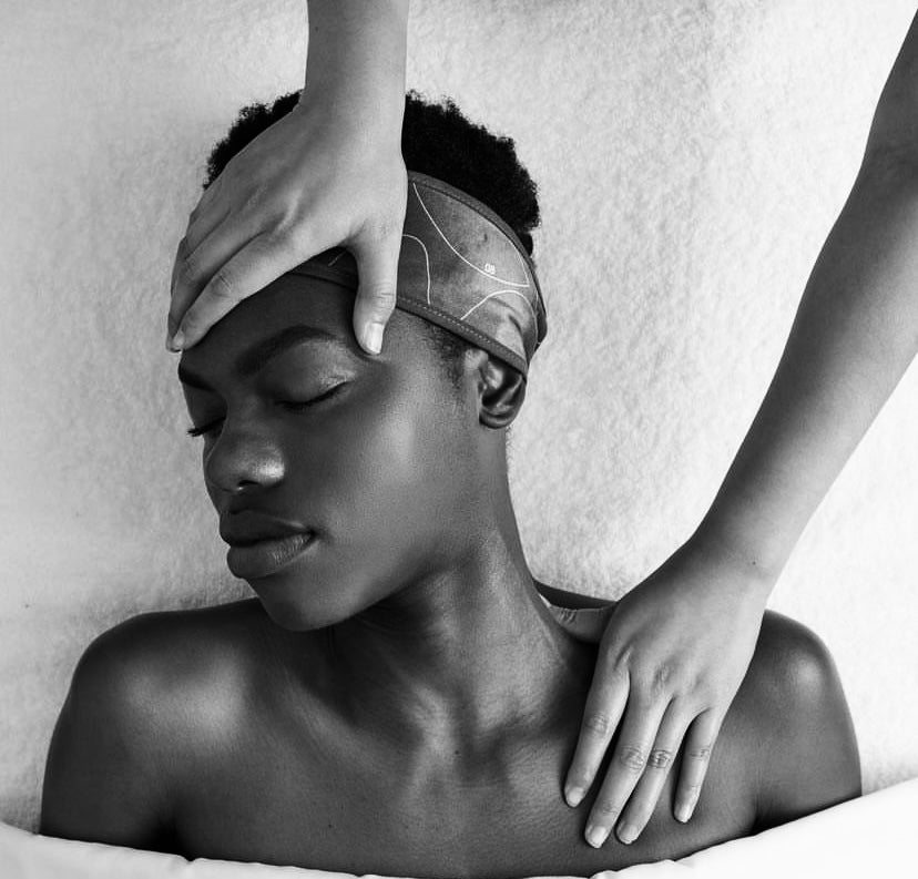 Stretching the neck during neck massage during facial