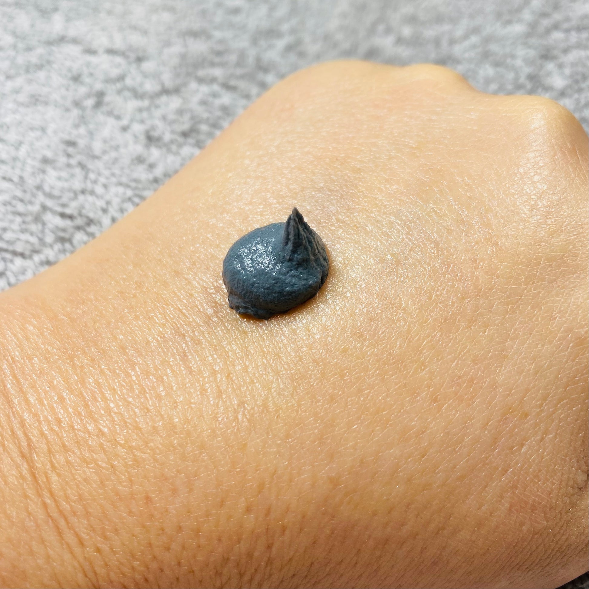 active clay cleanser on back of hand