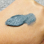 active clay cleanser spread on the back of hand